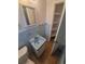 Bathroom with a light blue sink, toilet, storage, and blue tiled walls at 444 S Jersey St, Denver, CO 80224