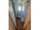 Narrow bathroom with a blue sink, toilet, window, and tiled walls at 444 S Jersey St, Denver, CO 80224