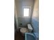 Bathroom featuring a window, toilet, sink, and blue wall tiles at 444 S Jersey St, Denver, CO 80224
