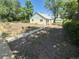 Quaint home featuring a spacious gravel driveway and yard with mature trees, offering plenty of outdoor space at 444 S Jersey St, Denver, CO 80224