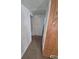 A hallway with carpet, white walls, and a glimpse of a doorway at 444 S Jersey St, Denver, CO 80224