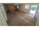 Bright living room featuring a combination of carpet and hardwood flooring and a large window at 444 S Jersey St, Denver, CO 80224