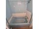 Full view of blue tiled shower/bathtub combination with white trim at 444 S Jersey St, Denver, CO 80224