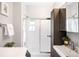 This bathroom features a white shower over tub, a vessel sink, and a dark wood storage cabinet at 3375 W 37Th Ave, Denver, CO 80211