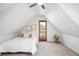 Attic bedroom with carpet, and a door to an outdoor balcony with a view of trees at 3375 W 37Th Ave, Denver, CO 80211