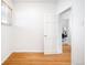Bright bedroom with hardwood floors and a glimpse of a laundry room at 3375 W 37Th Ave, Denver, CO 80211