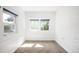 Bright bedroom with neutral carpet, white walls, and ample natural light from two windows at 3375 W 37Th Ave, Denver, CO 80211