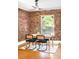 Dining area featuring exposed brick wall, hardwood floors, and a modern ceiling fan at 3375 W 37Th Ave, Denver, CO 80211