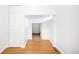 Hallway with hardwood floors, leading to a room with carpet and a doorway at 3375 W 37Th Ave, Denver, CO 80211