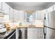 Bright, tidy kitchen featuring stainless steel appliances, granite counters and white cabinets at 3375 W 37Th Ave, Denver, CO 80211
