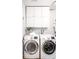 This laundry room features white cabinets, and Samsung front loading washer and dryer at 3375 W 37Th Ave, Denver, CO 80211