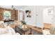 Cozy living room with exposed brick, hardwood floors, and a view into the entryway at 3375 W 37Th Ave, Denver, CO 80211