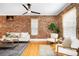 Bright living room with exposed brick wall, hardwood floors, and ample seating at 3375 W 37Th Ave, Denver, CO 80211