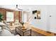Open-concept living space with exposed brick, modern art, and hardwood flooring at 3375 W 37Th Ave, Denver, CO 80211