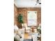 Stylish living room with exposed brick wall, comfortable seating, and natural light at 3375 W 37Th Ave, Denver, CO 80211