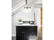 This vanity features a black granite countertop, a white sink, and a three light sconce, and a plant at 3375 W 37Th Ave, Denver, CO 80211