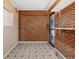 Unfinished basement room with brick walls and shelving at 323 Fulton St, Aurora, CO 80010