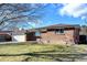 Brick ranch home with attached garage and spacious yard at 323 Fulton St, Aurora, CO 80010