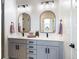 Modern bathroom with dual vanity and arched mirrors at 10864 Lyric St, Lone Tree, CO 80134