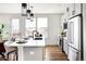 Modern kitchen with island, stainless steel appliances, and white cabinetry at 10864 Lyric St, Lone Tree, CO 80134