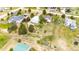 Aerial view showcasing the white fencing, workshop, lush greenery, driveway, and neighboring residences in a serene setting at 5685 Columbine Ridge Rd, Elizabeth, CO 80107