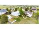 Aerial shot showcases a home with a workshop, white fencing, lush greenery, back deck, and carefully laid landscaping at 5685 Columbine Ridge Rd, Elizabeth, CO 80107