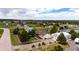 Aerial view of a home on a large lot featuring mature trees, landscaping, and outbuildings at 5685 Columbine Ridge Rd, Elizabeth, CO 80107