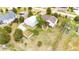 Aerial view of home highlighting landscaping, white fencing, workshop, driveway, back deck, and lush greenery at 5685 Columbine Ridge Rd, Elizabeth, CO 80107