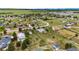 Aerial view featuring white fencing, a workshop, lush greenery, neighboring houses, and a trampoline on the property at 5685 Columbine Ridge Rd, Elizabeth, CO 80107