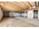 Unfinished basement with exposed beams and door to stairs at 5685 Columbine Ridge Rd, Elizabeth, CO 80107