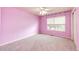 Bright bedroom with pink walls, carpet, and window at 5685 Columbine Ridge Rd, Elizabeth, CO 80107