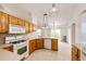 The kitchen features natural light, tile floors, and wood cabinets at 5685 Columbine Ridge Rd, Elizabeth, CO 80107