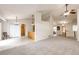 Open-concept living room featuring neutral tones, carpet flooring, and natural light at 5685 Columbine Ridge Rd, Elizabeth, CO 80107