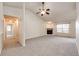 Comfortable living room featuring neutral carpet, fireplace, and ample open space at 5685 Columbine Ridge Rd, Elizabeth, CO 80107