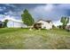 A large open yard with a barn and two-story home nestled amidst a lush green landscape at 5685 Columbine Ridge Rd, Elizabeth, CO 80107