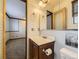 Bathroom featuring a single sink vanity and a view into the adjacent bedroom at 4589 S Evanston St, Aurora, CO 80015