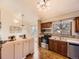 Well-lit kitchen features stainless steel appliances, tile backsplash, wood cabinets, and hardwood floors at 4589 S Evanston St, Aurora, CO 80015