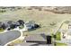 Home situated on a lot with a spacious lawn and a white fence, backing onto an open field at 5996 Sun Mesa Cir, Castle Rock, CO 80104