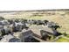 Aerial perspective revealing a home with a spacious lawn, bordered by a white fence and a natural landscape at 5996 Sun Mesa Cir, Castle Rock, CO 80104