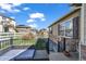 Relaxing back deck with comfortable seating and views of the fenced backyard and surrounding neighborhood at 5996 Sun Mesa Cir, Castle Rock, CO 80104