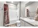 Well-lit bathroom with tile floors, shower-tub combo, white cabinets and modern sink at 5996 Sun Mesa Cir, Castle Rock, CO 80104