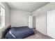 Minimalist bedroom with a comfortable bed, neutral walls, carpeted floors, and a window at 5996 Sun Mesa Cir, Castle Rock, CO 80104