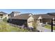 Home exterior featuring stone accents, attached garage, and a well-maintained yard with a white fence at 5996 Sun Mesa Cir, Castle Rock, CO 80104