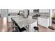 Modern kitchen with granite countertops, stainless steel appliances and a large center island with barstool seating at 5996 Sun Mesa Cir, Castle Rock, CO 80104