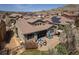 Aerial view showcasing the home's backyard with a patio, fire pit, and neighborhood surroundings with mountain views at 2236 S Isabell Ct, Lakewood, CO 80228