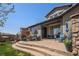 Covered backyard patio, complete with outdoor furniture and a grill for entertaining and relaxing at 2236 S Isabell Ct, Lakewood, CO 80228