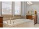 Bright bathroom with a soaking tub, mosaic tile, and decorative window shades at 2236 S Isabell Ct, Lakewood, CO 80228