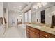 Spacious bathroom with dual vanities, soaking tub, glass shower, and neutral tile at 2236 S Isabell Ct, Lakewood, CO 80228