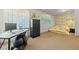 This bedroom features a work space, green and brown floral wallpaper, and a large painting of a wave at 2236 S Isabell Ct, Lakewood, CO 80228