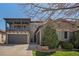 Stunning two-story home with a balcony, three-car garage, stone accents, and professionally landscaped front yard at 2236 S Isabell Ct, Lakewood, CO 80228